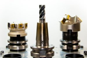 An image of three drill bits that are coated with a soft metal coating for reduction of wear of the metal bits.