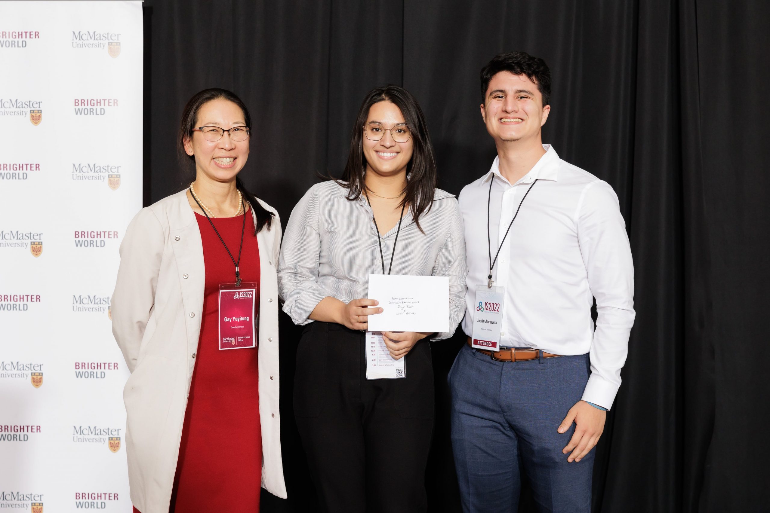 Gay Yuyitung, executive director of MILO, presents the Commercial Potential award to Paige Chandran Blair and Justin Alvarado.