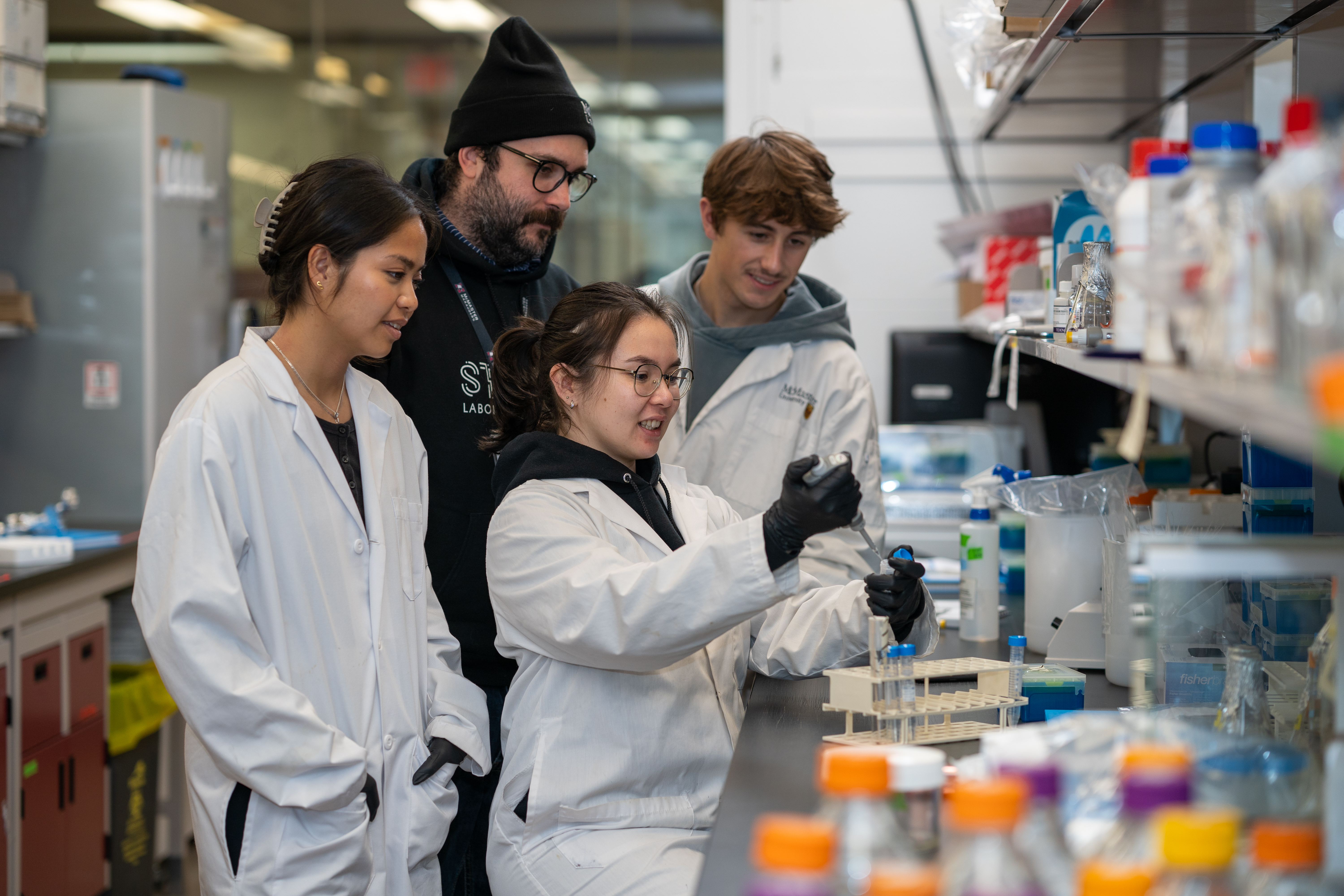 Jon Stokes and students working in a lab.